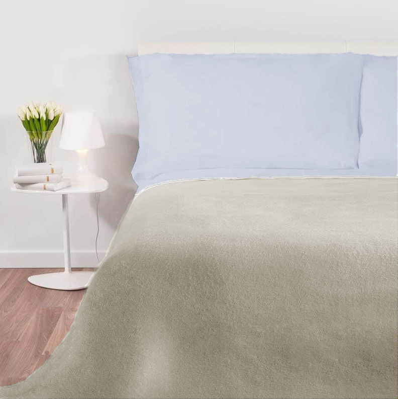 Een bed met een Good Nihgt deken antraciet met de licht kleur aan de ene kant